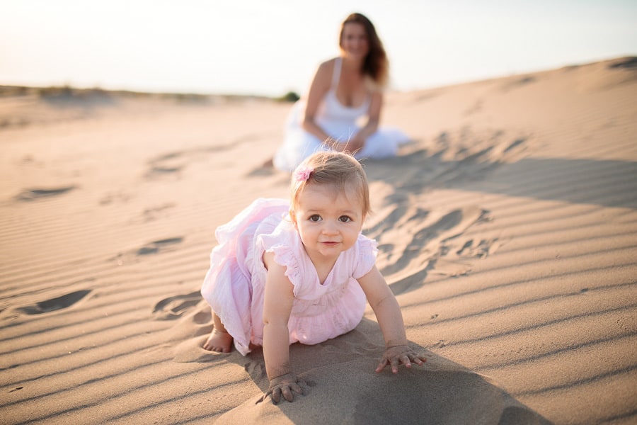 bébé qui marche à quatre pattes dans le sable